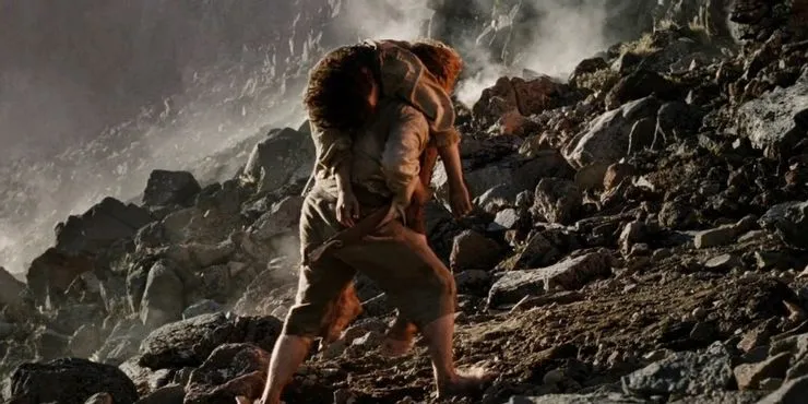 Sam carries Frodo up Mount Doom during the Black Gate battle.