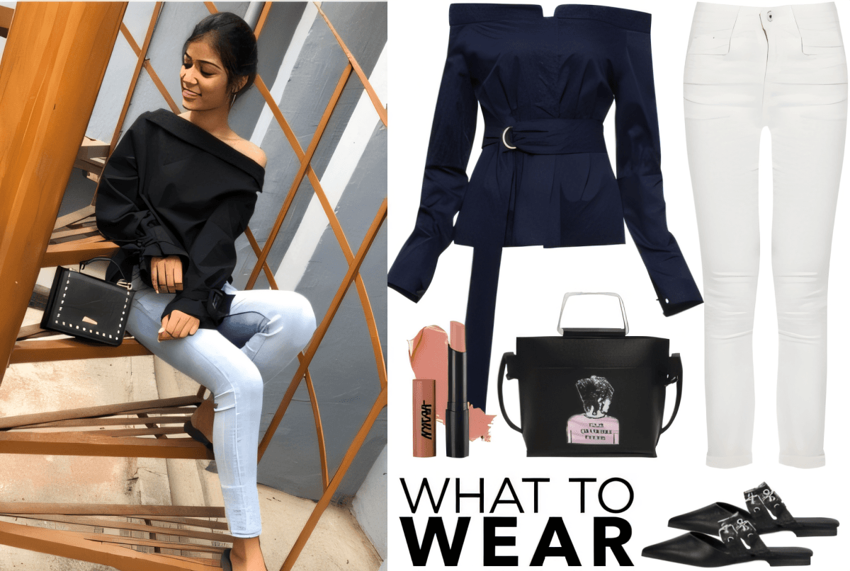 Tenue chic composée d'un haut bleu marine à épaules dénudées, d'un jean blanc, de mules noires et d'un sac à main noir structuré