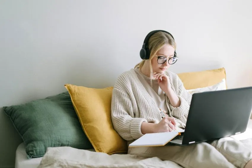 woman with headphones woman with headphones on taking notes
