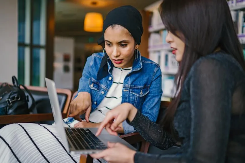 Two people looking at a computer