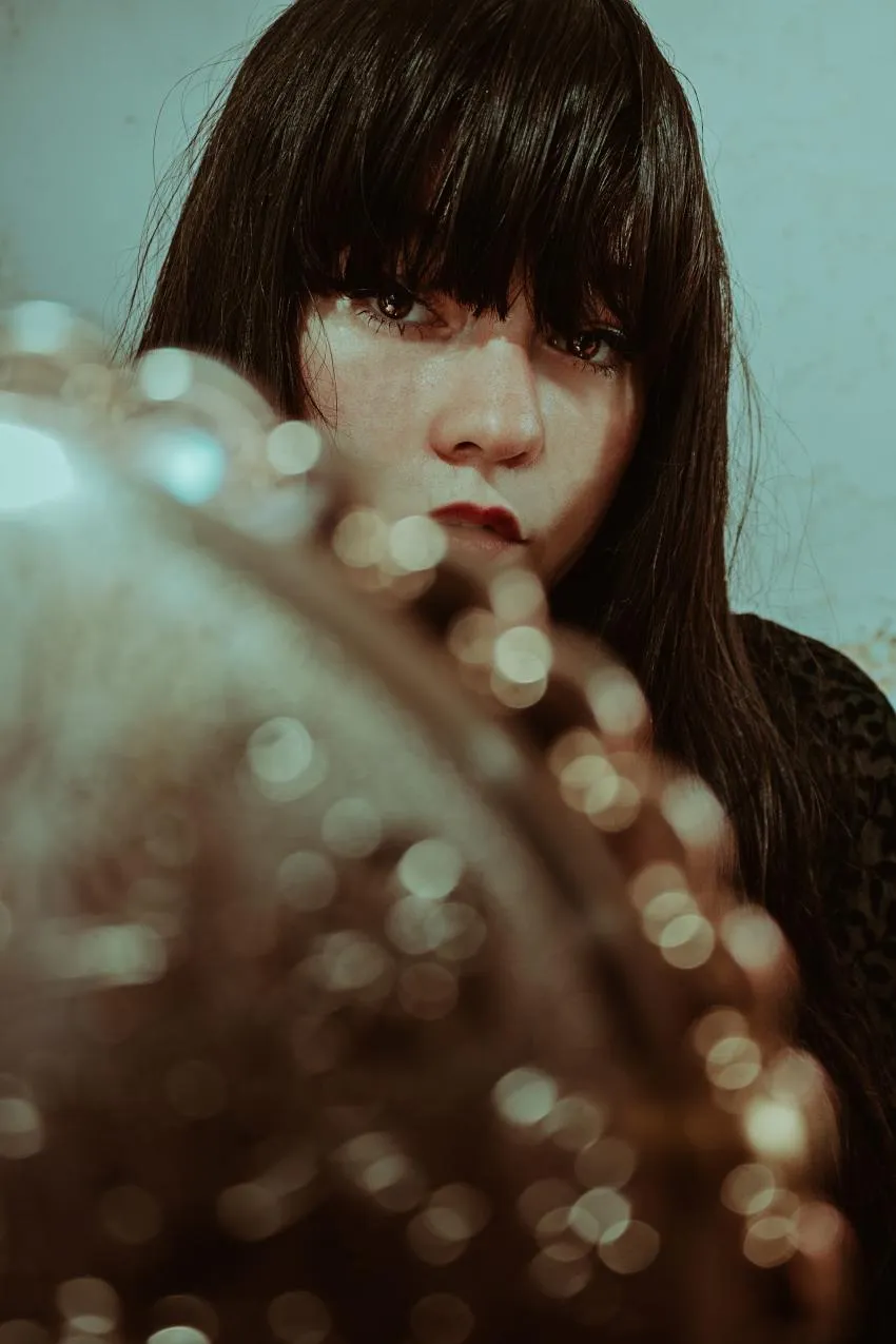 Woman looking in mirror and impact of fashion on mental health