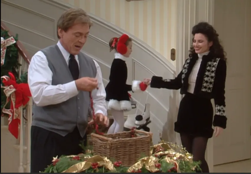 Fran Fine wearing black holiday jacket with matching skirt