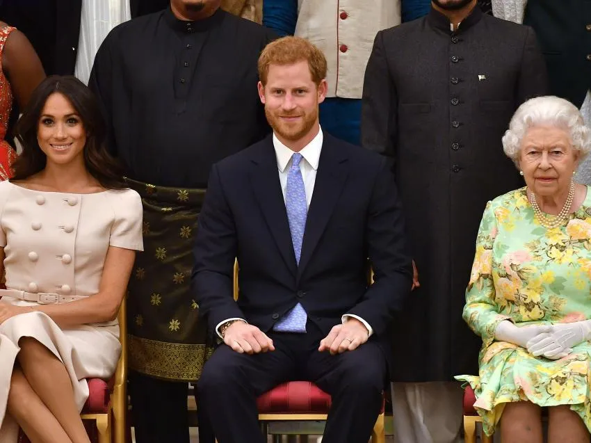 The Queen sits with Meghan Markle and Prince Harry