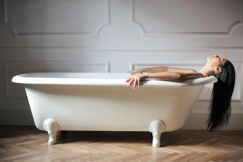 A person luxuriating in a bath