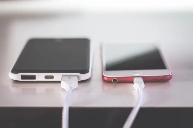 two phones charging on table