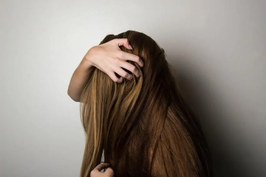 A girl holding hair hair