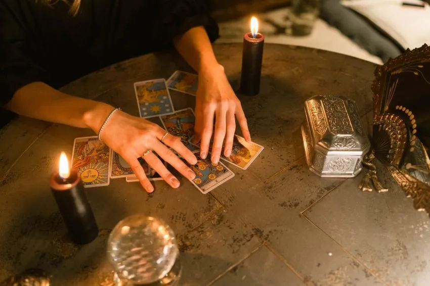 A hand holding tarot cards