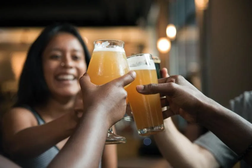 People toasting with glasses of beer