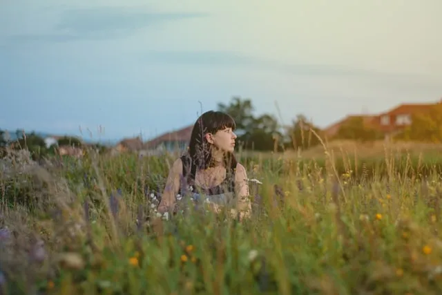 lady sitting in flower field