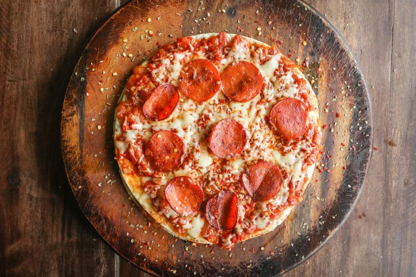 Pizza A Pepperoni Pizza With Crushed Chillis and Seeds