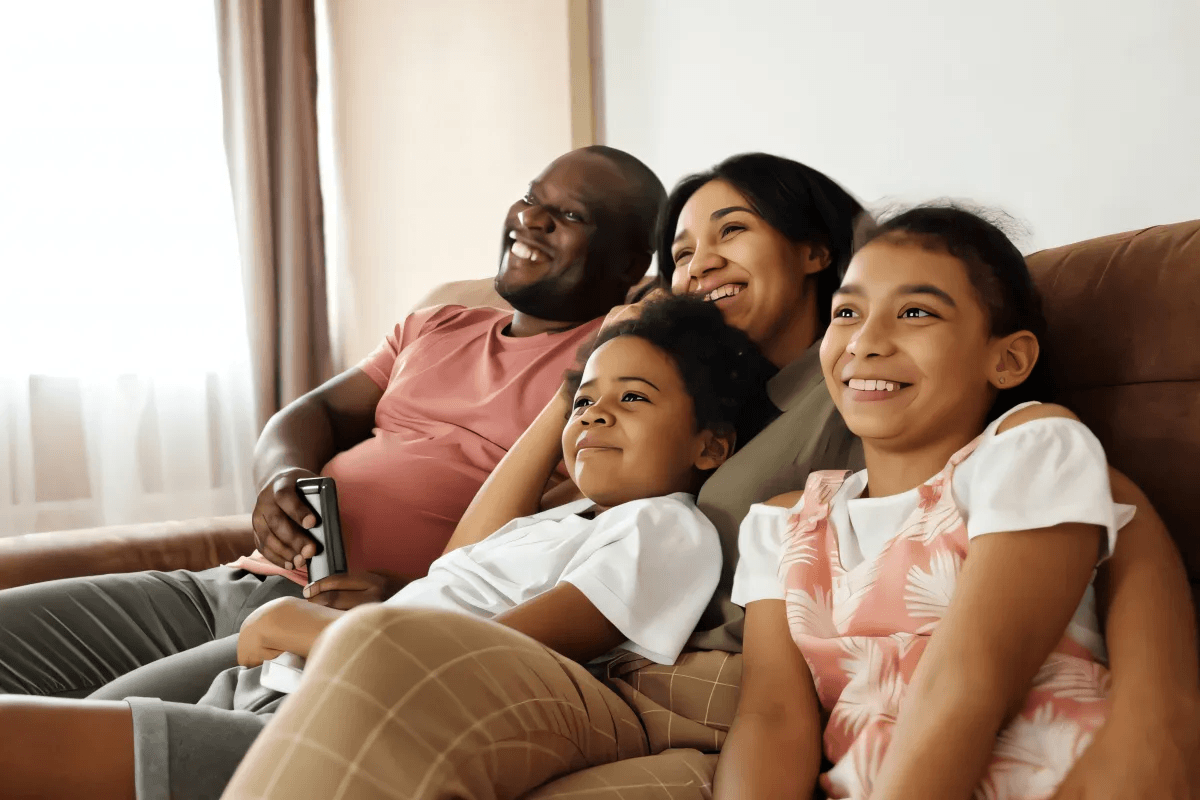 Family on couch laughing