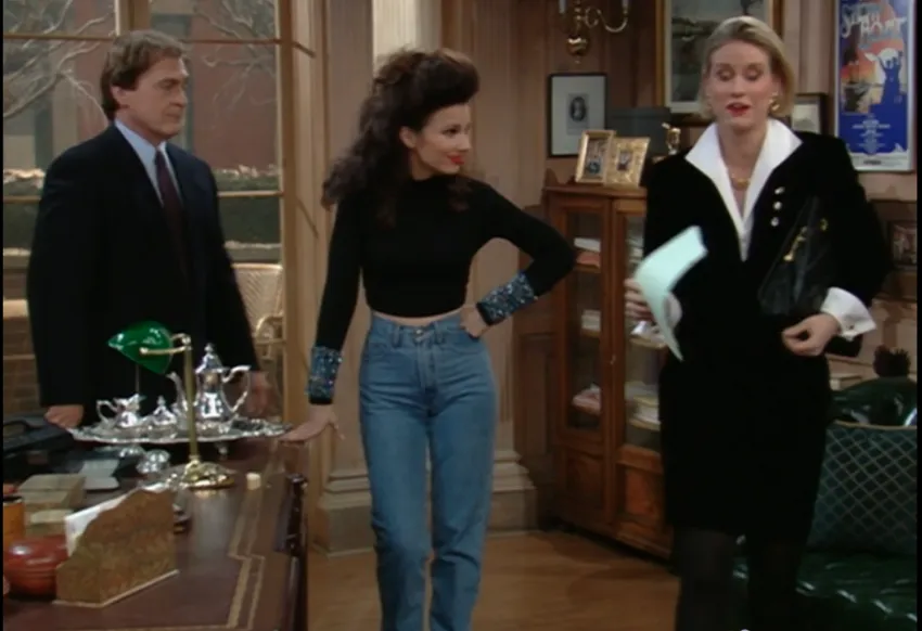 Fran Fine wearing jeans and black sweater with sparkly sleeves