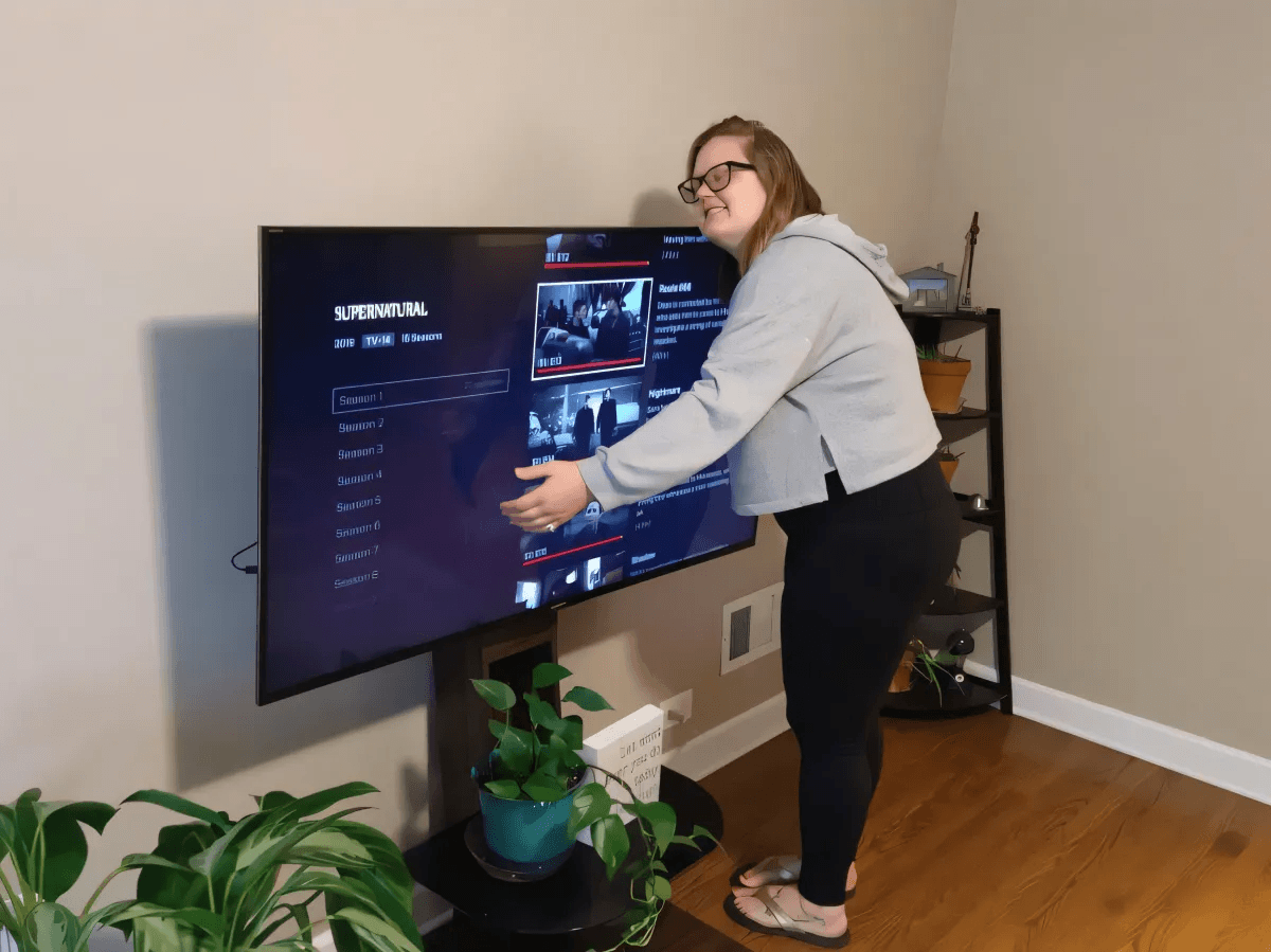 Woman hugging her television