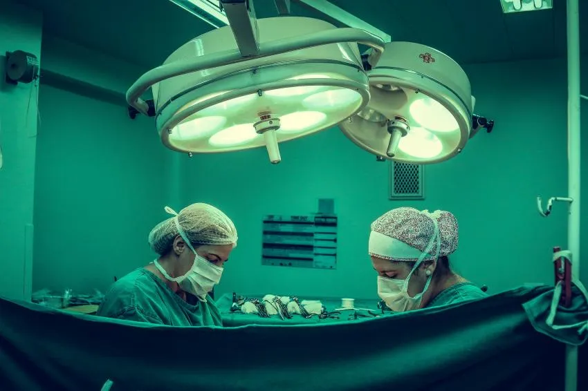 Surgeons performing an operation with surgical masks on