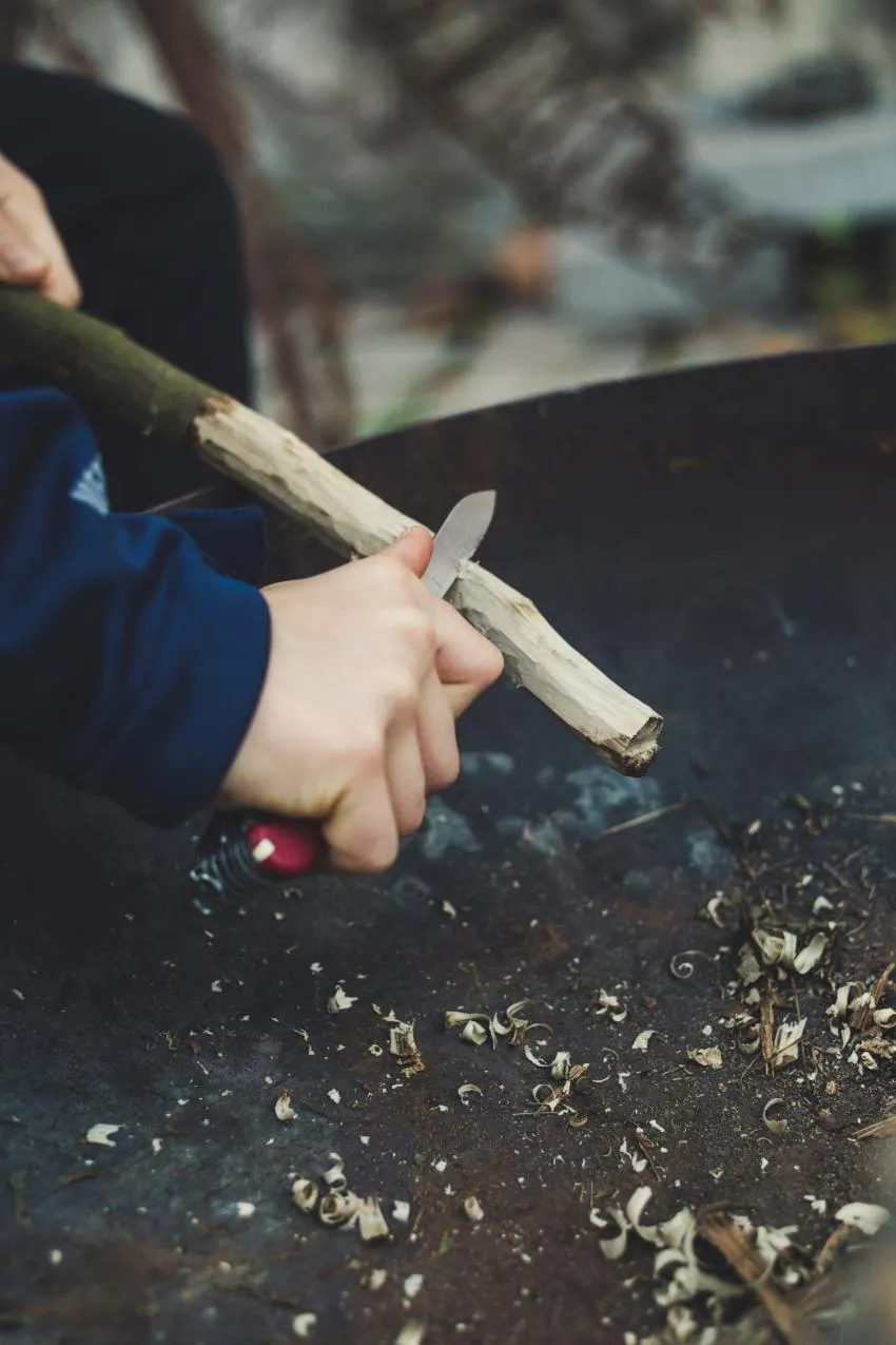 man carving stick man carving stick