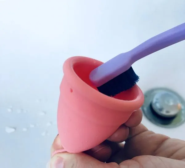 Use a toothbrush to clean your cup