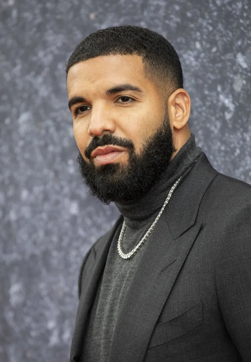 Drake poses for a photo Drake on the red carpet for a picture
